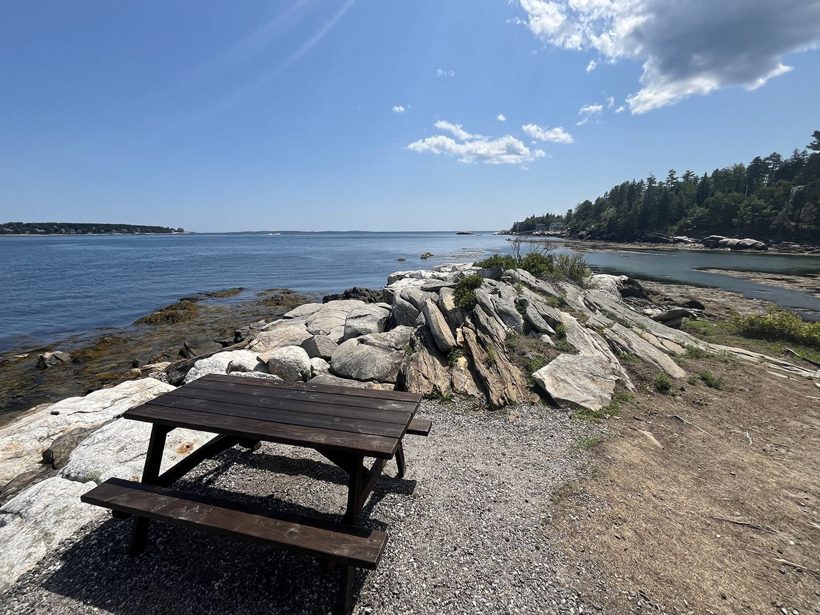 Picnic table on the rocky shoreline overlooking the ocean