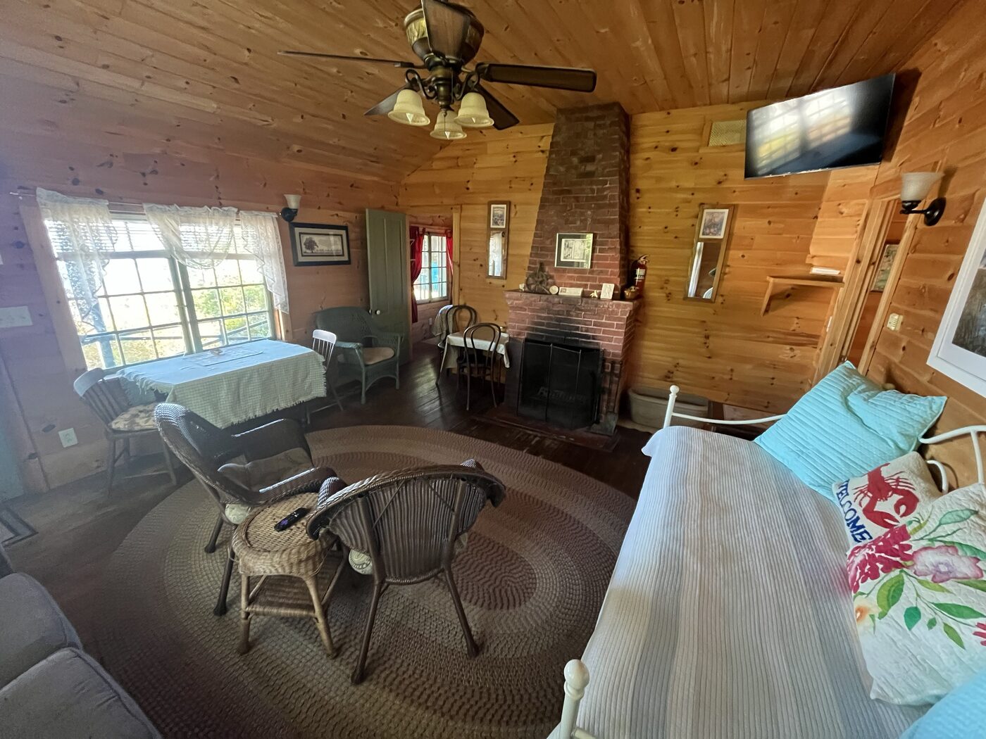Living room with brick fireplace inside Hillside Cottage