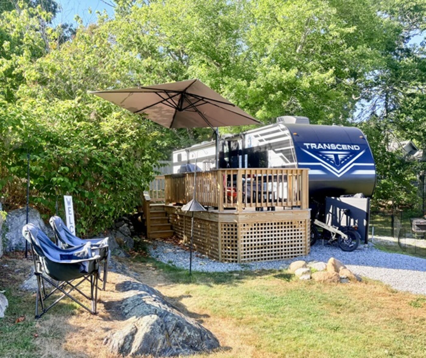 2024 Grand Design Transcend Xplor 331BH travel trailer on a waterfront seasonal site